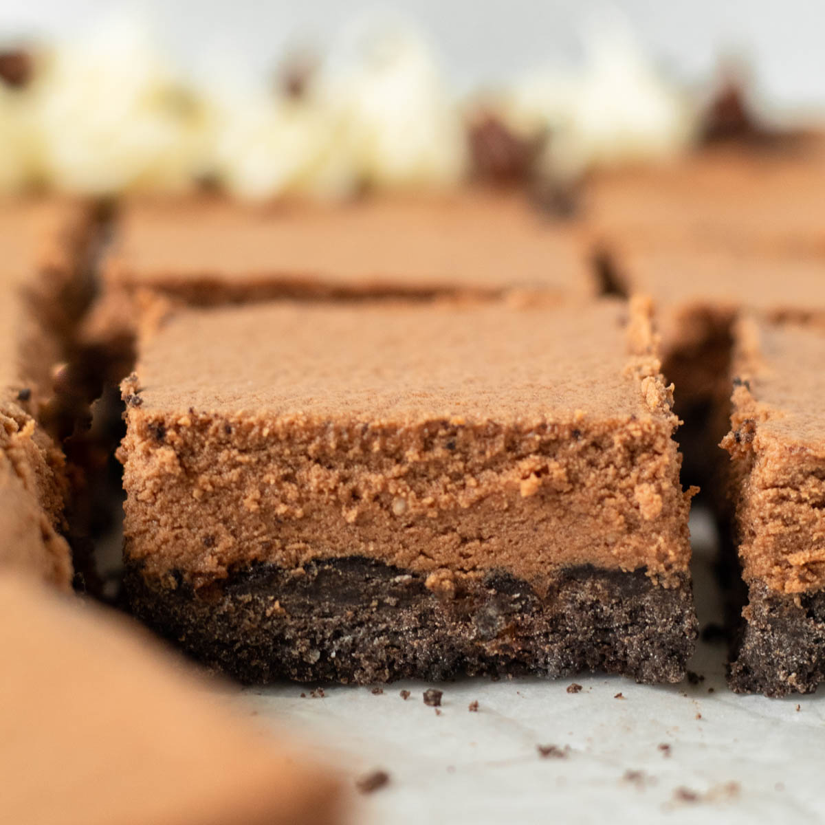 These Gluten-Free French Silk Pie Bars are a decadent chocolate pie recipe made with a gluten-free Oreo crust and rich chocolate mousse on top. These pie bars are the perfect dessert for a crowd and make a great holiday dessert.