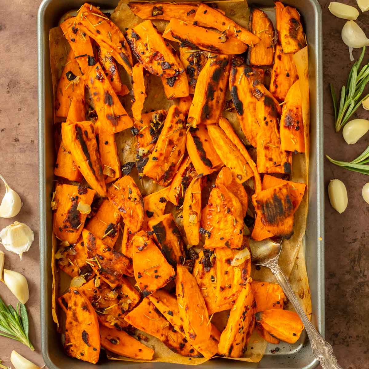 These Roasted Sweet Potato Wedges are crispy oven-roasted sweet potatoes seasoned with salt, garlic, onion and rosemary for the perfect easy side dish recipe. This sweet potato side dish is perfect for an easy weeknight meal and also great for meal prep.