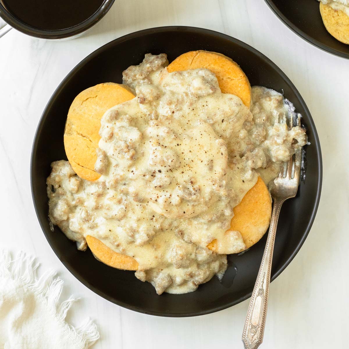 This gluten-free biscuits and gravy is a delicious classic comfort food breakfast made with homemade gluten-free biscuits topped with a simple 4-ingredient sausage gravy.