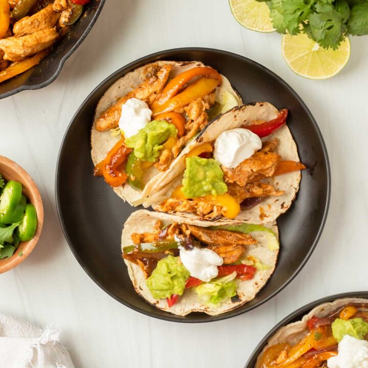 These chicken fajitas are a one-pan dinner made with chicken and vegetables cooked in a homemade fajita sauce and served in a tortilla and your favorite fajita toppings.