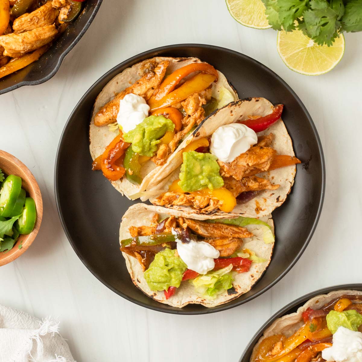 These chicken fajitas are a one-pan dinner made with chicken and vegetables cooked in a homemade fajita sauce and served in a tortilla and your favorite fajita toppings.