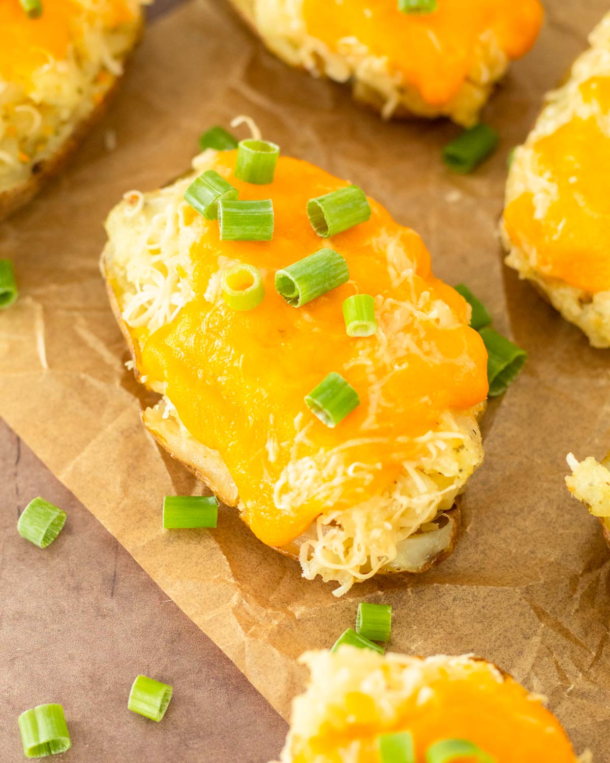 These twice baked potatoes are a classic summer side dish made with russet potatoes loaded with cheesy, flavorful mashed potatoes and topped with cheese. Serve this easy potato side at a summer cookout or Fourth of July party.