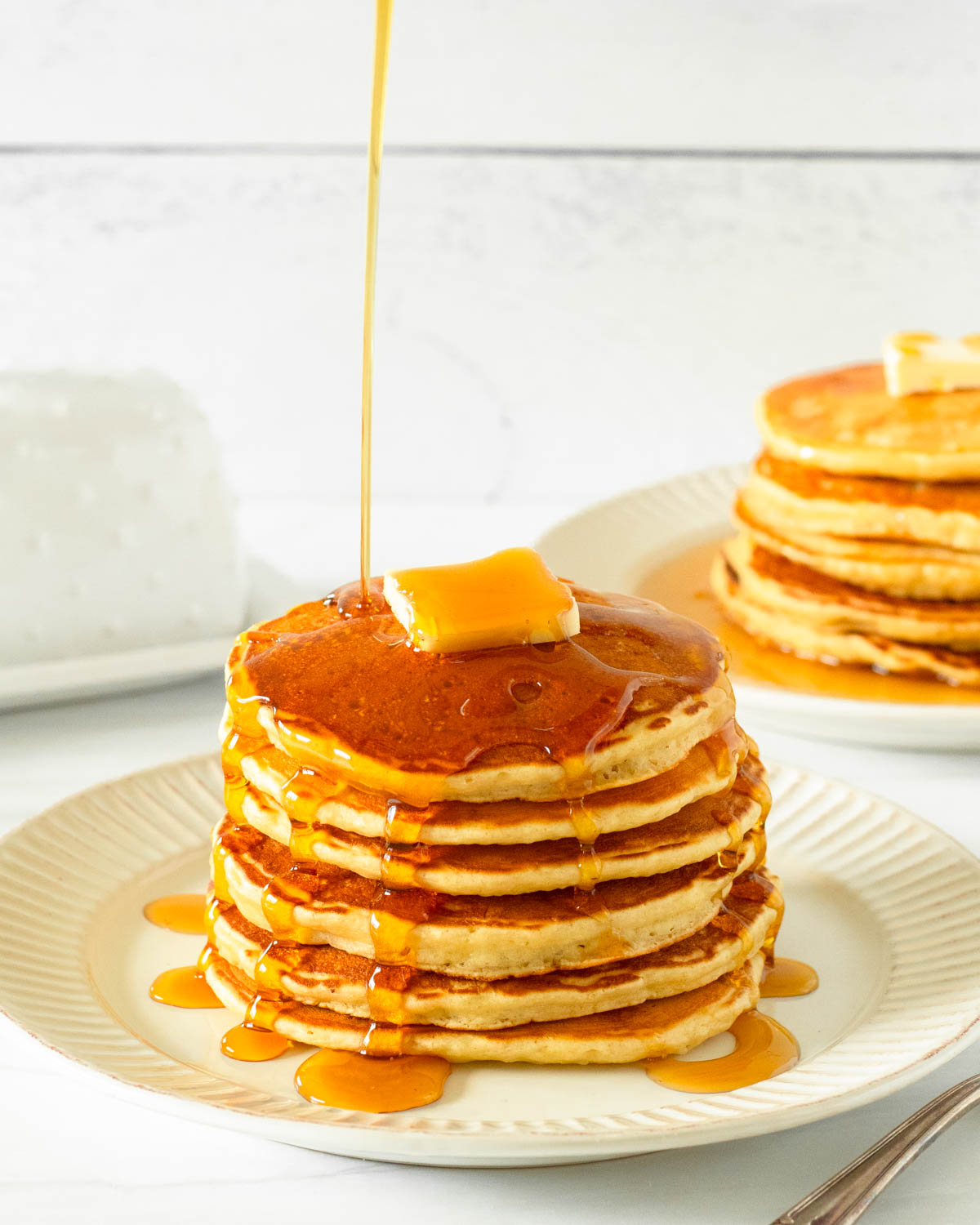 These gluten-free pancakes are a classic breakfast staple made with simple ingredients including gluten-free flour, milk, an egg, butter and honey for a delicious homemade breakfast.