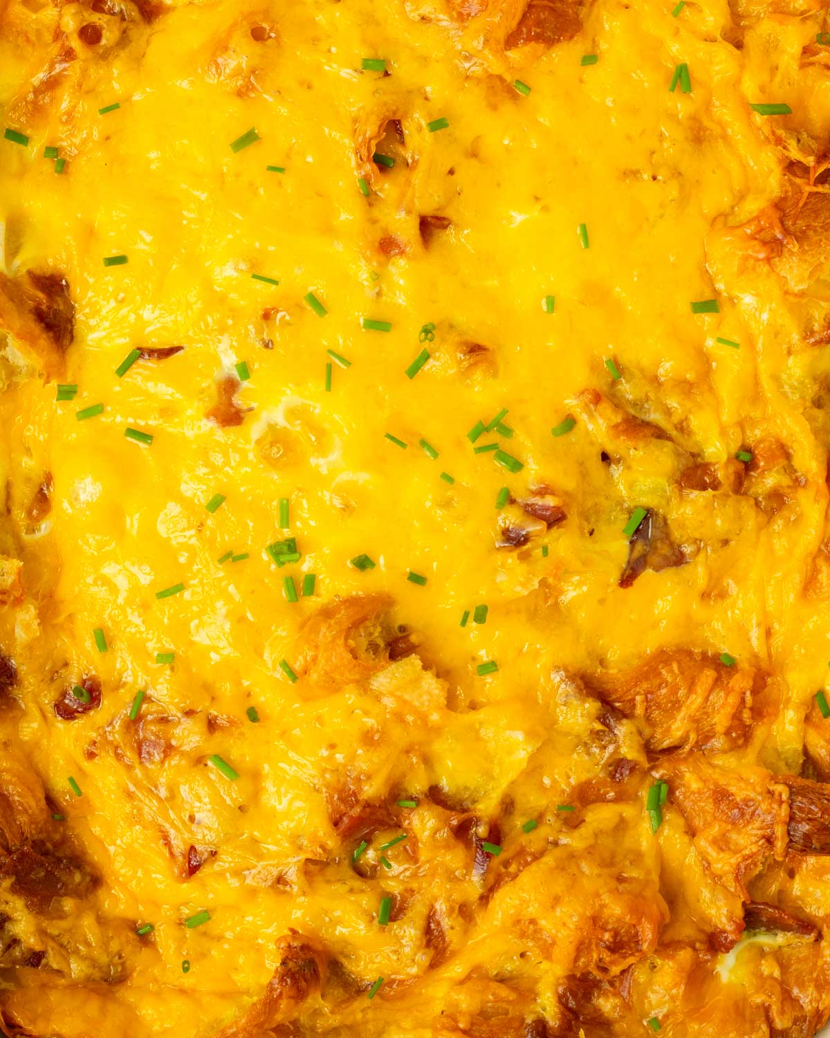 This bacon cheddar croissant breakfast casserole is an easy 5-ingredient breakfast recipe made buttery croissants and bacon baked in cheesy fluffy eggs for the perfect breakfast to serve a crowd.