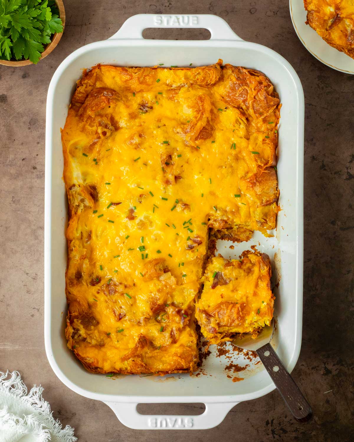 This bacon cheddar croissant breakfast casserole is an easy 5-ingredient breakfast recipe made buttery croissants and bacon baked in cheesy fluffy eggs for the perfect breakfast to serve a crowd.