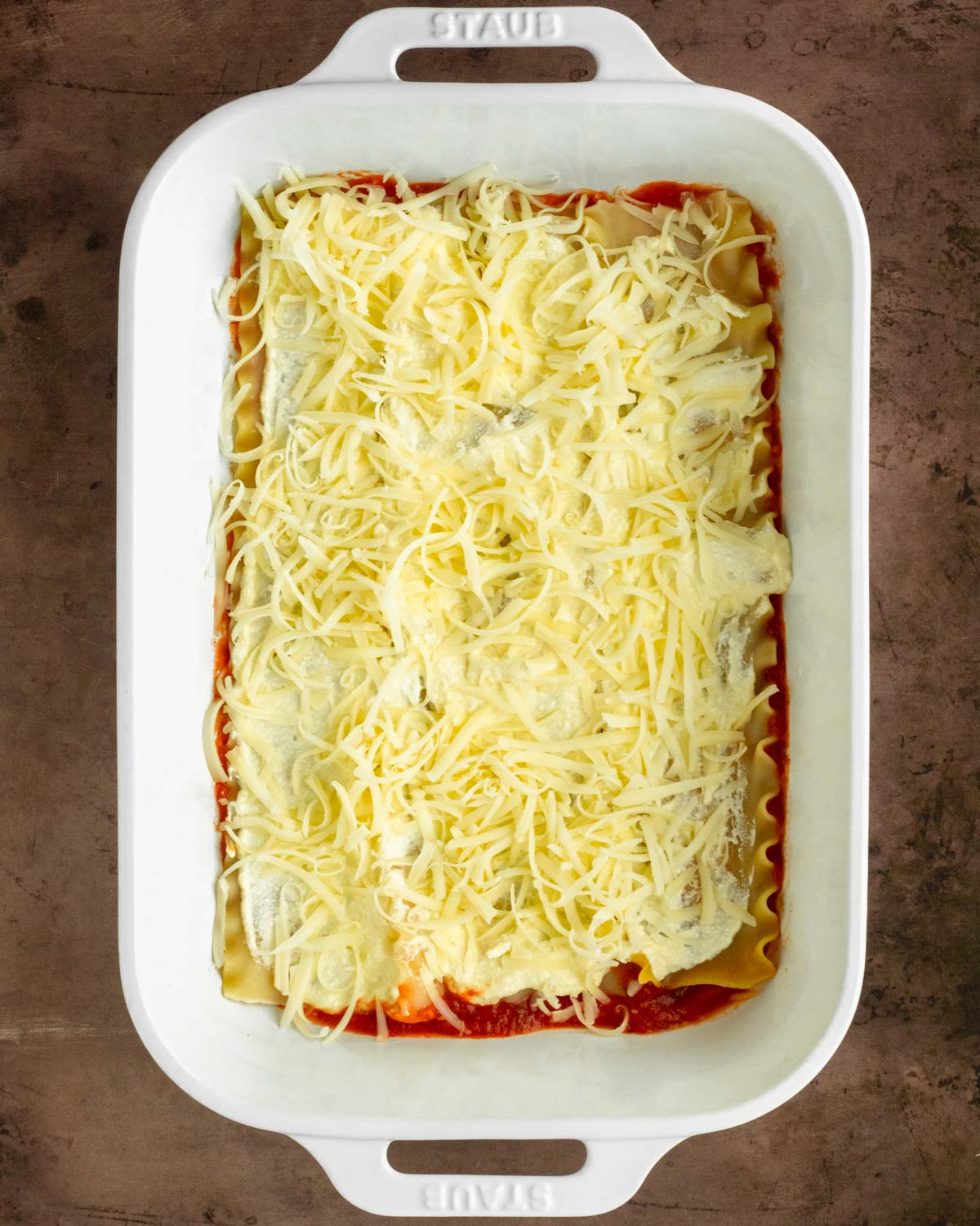 Step 2. Spread a layer of ricotta & cheese over the noodles