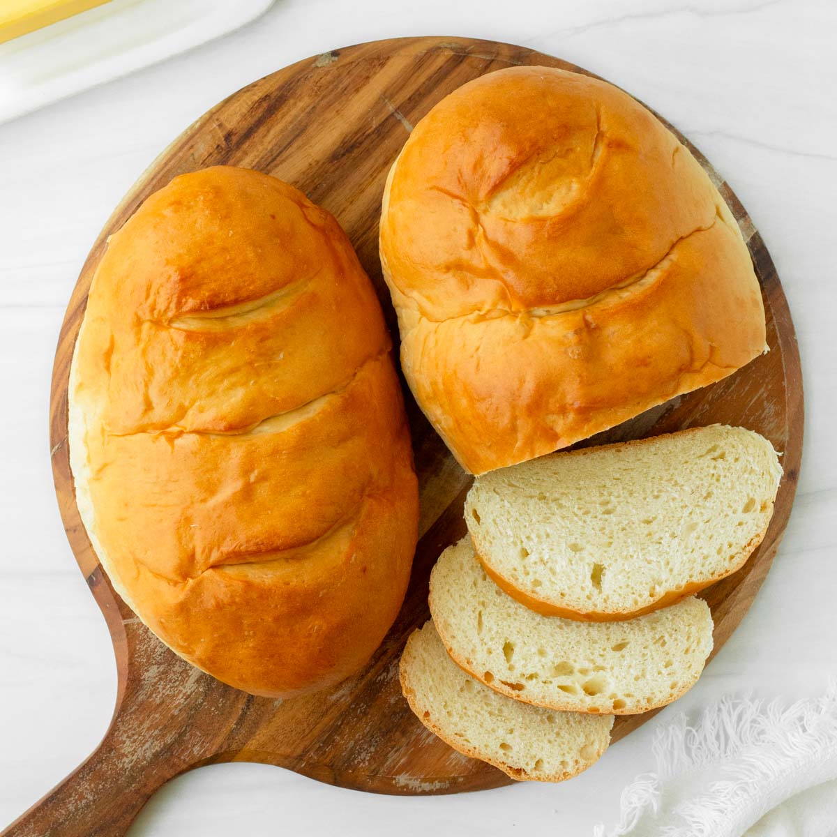 This homemade French bread recipe is an easy yeast bread recipe made with simple ingredients for a flavorful, soft bread perfect for using in French toast, sandwiches like grilled cheese, and making into French bread pizza.