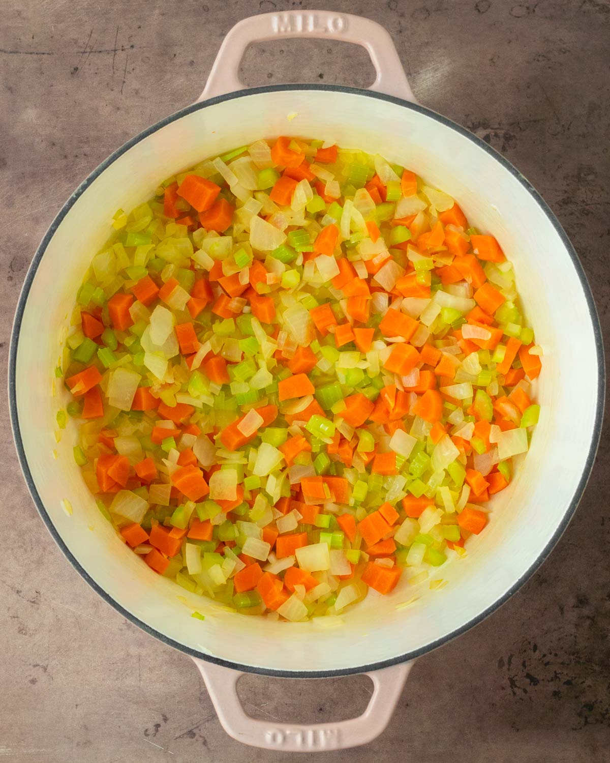 Step 1. Add the butter, onion, carrots, and celery to the Dutch oven and cook to soften then add the garlic