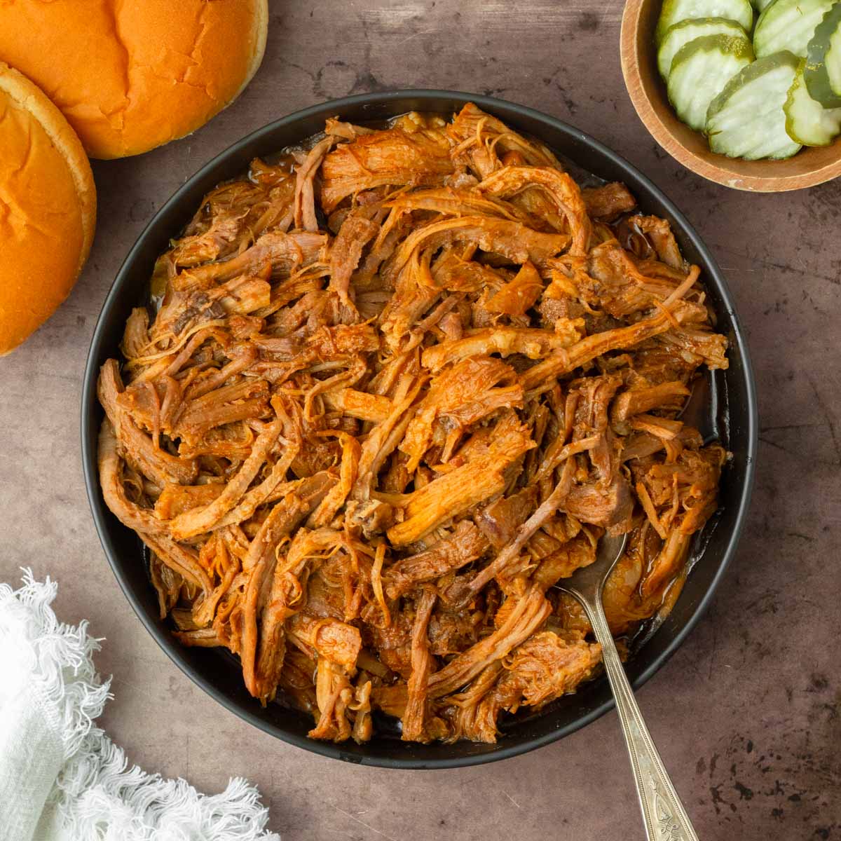 This crockpot BBQ pulled pork recipe is a great slower cooker pork recipe perfect for easy weeknight dinners and delicious summer cookouts.