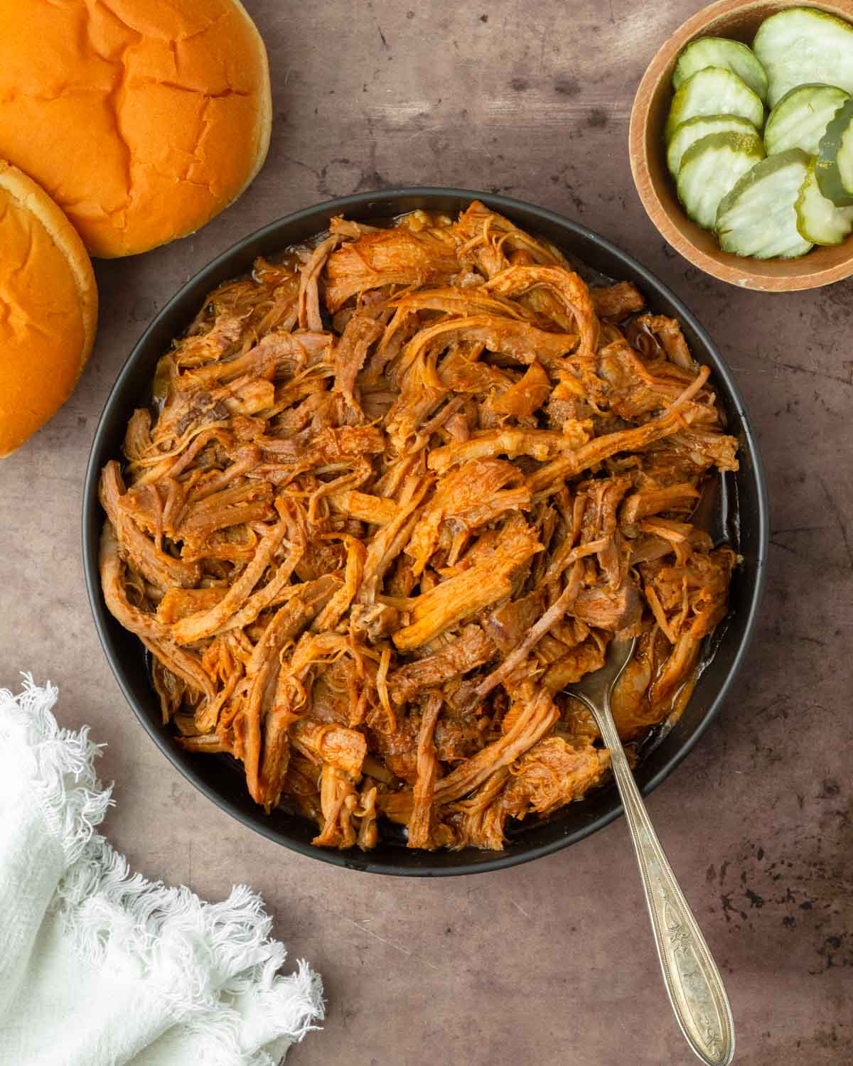 This crockpot BBQ pulled pork recipe is a great slower cooker pork recipe perfect for easy weeknight dinners and delicious summer cookouts.