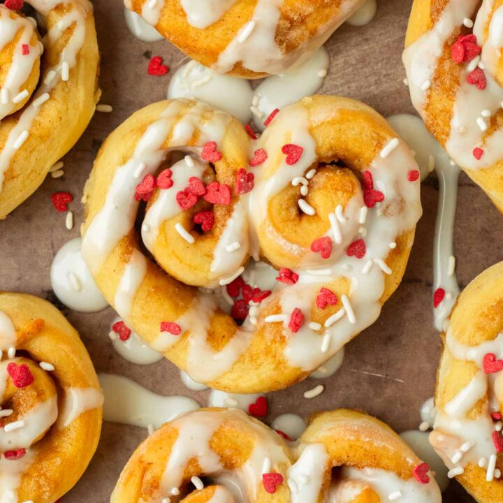 These heart shaped cinnamon rolls are the perfect easy and delicious Valentine's day treat. Made with our classic cinnamon roll recipe and shaped into hearts, this dessert is an easy to make crowd-pleaser recipe!