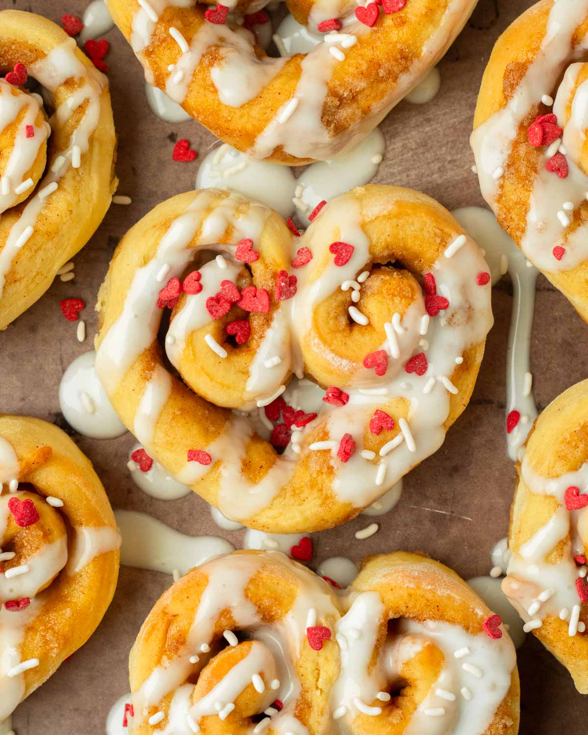 These heart shaped cinnamon rolls are the perfect easy and delicious Valentine's day treat. Made with our classic cinnamon roll recipe and shaped into hearts, this dessert is an easy to make crowd-pleaser recipe!