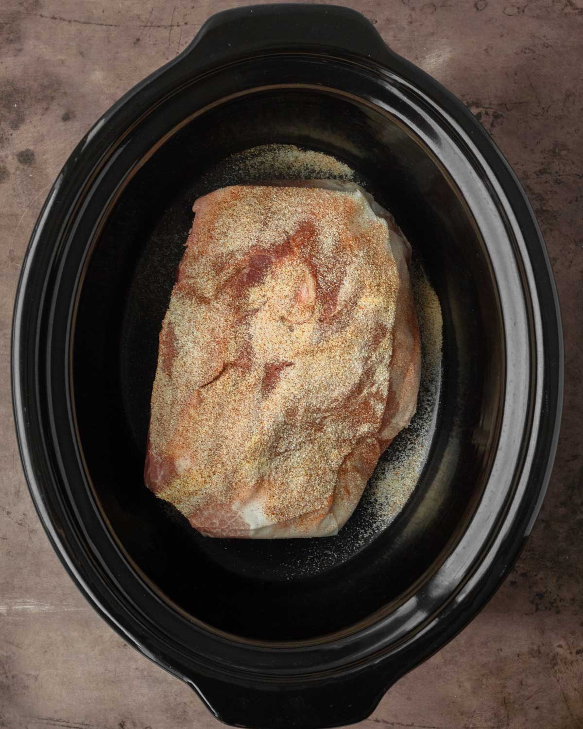 Step 1. Place the pork in the crockpot and sprinkle the spices on top