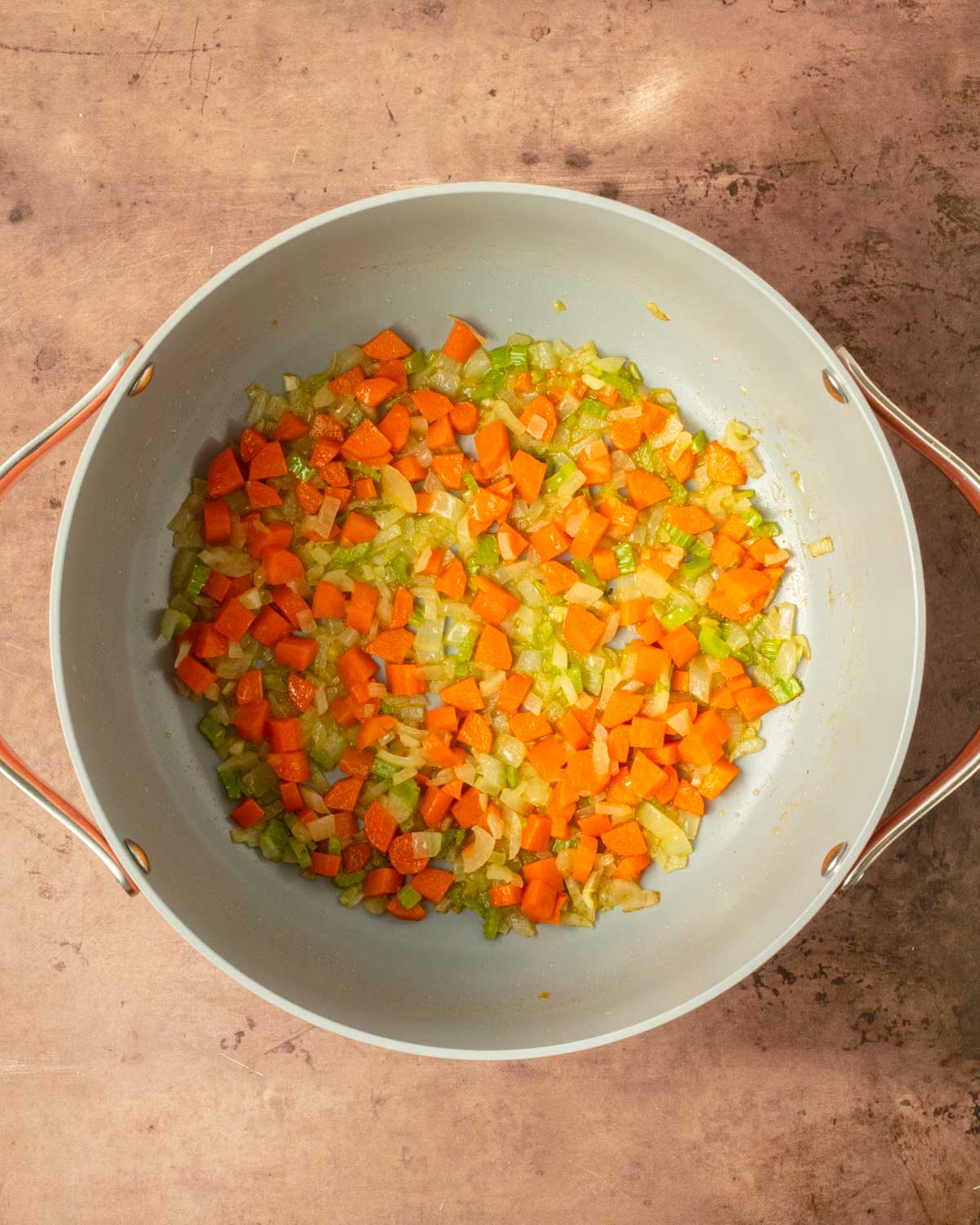 Step 1. Add the butter, onion, minced garlic, carrots, and celery to a large pot